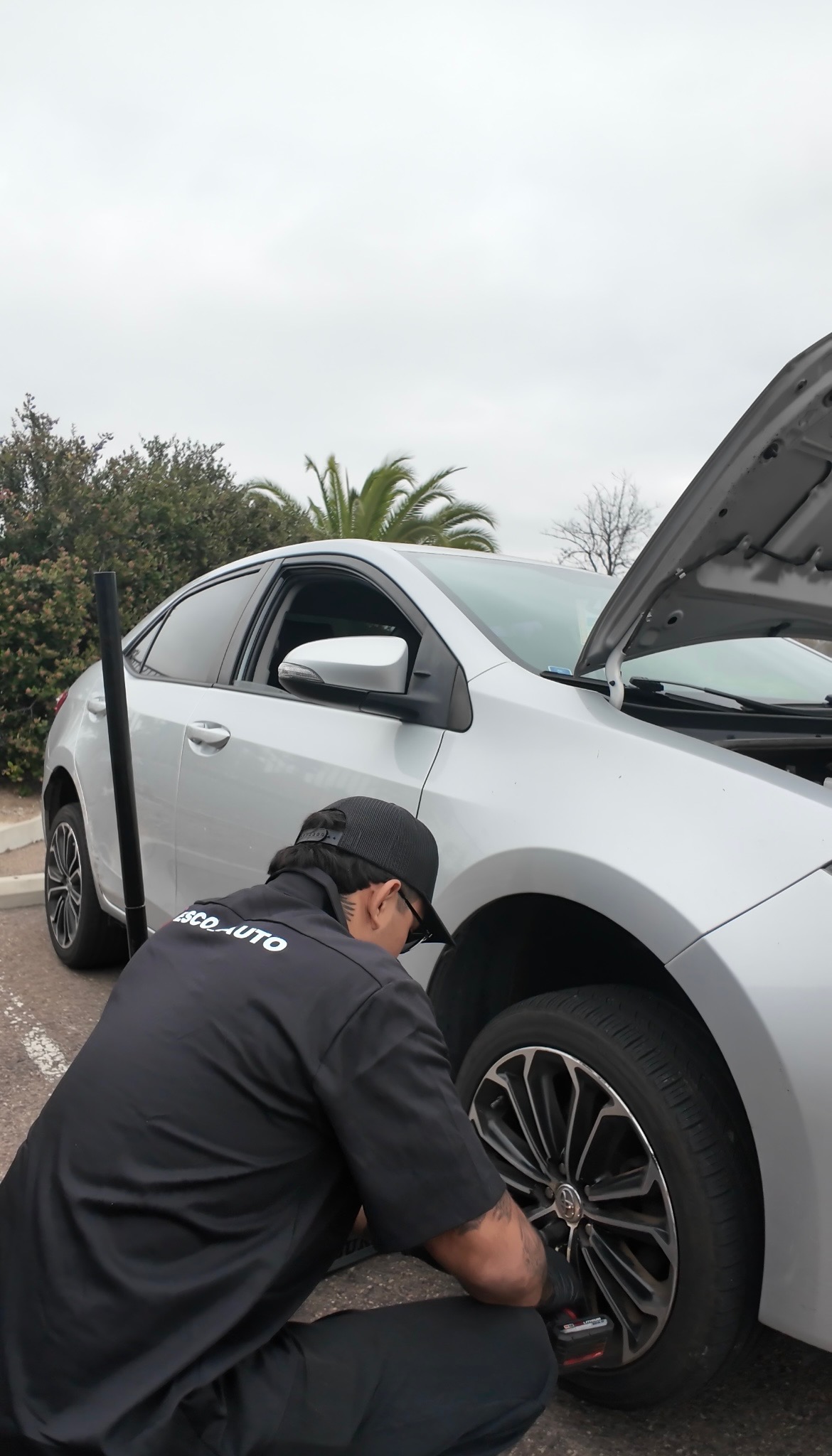 Esco Auto technician working on a wheel service